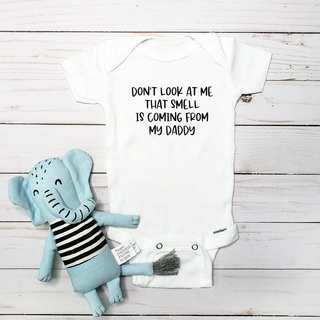Don't Look at Me, That Smell Is Coming From My Daddy baby bodysuit lifestyle photo - white bodysuit displayed near elephant nursery decor