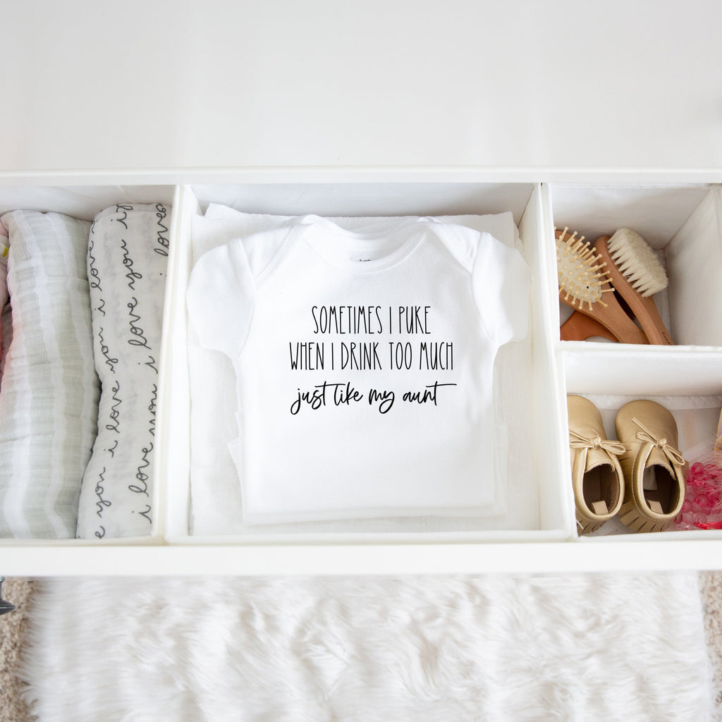 Sometimes I Puke When I Drink Too Much - Just Like My Aunt baby bodysuit lifestyle photo - white bodysuit folded in a dresser drawer