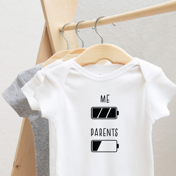 Battery: Me and Parents baby bodysuit lifestyle photo - white bodysuit hanging on a wooden hanger, close-up