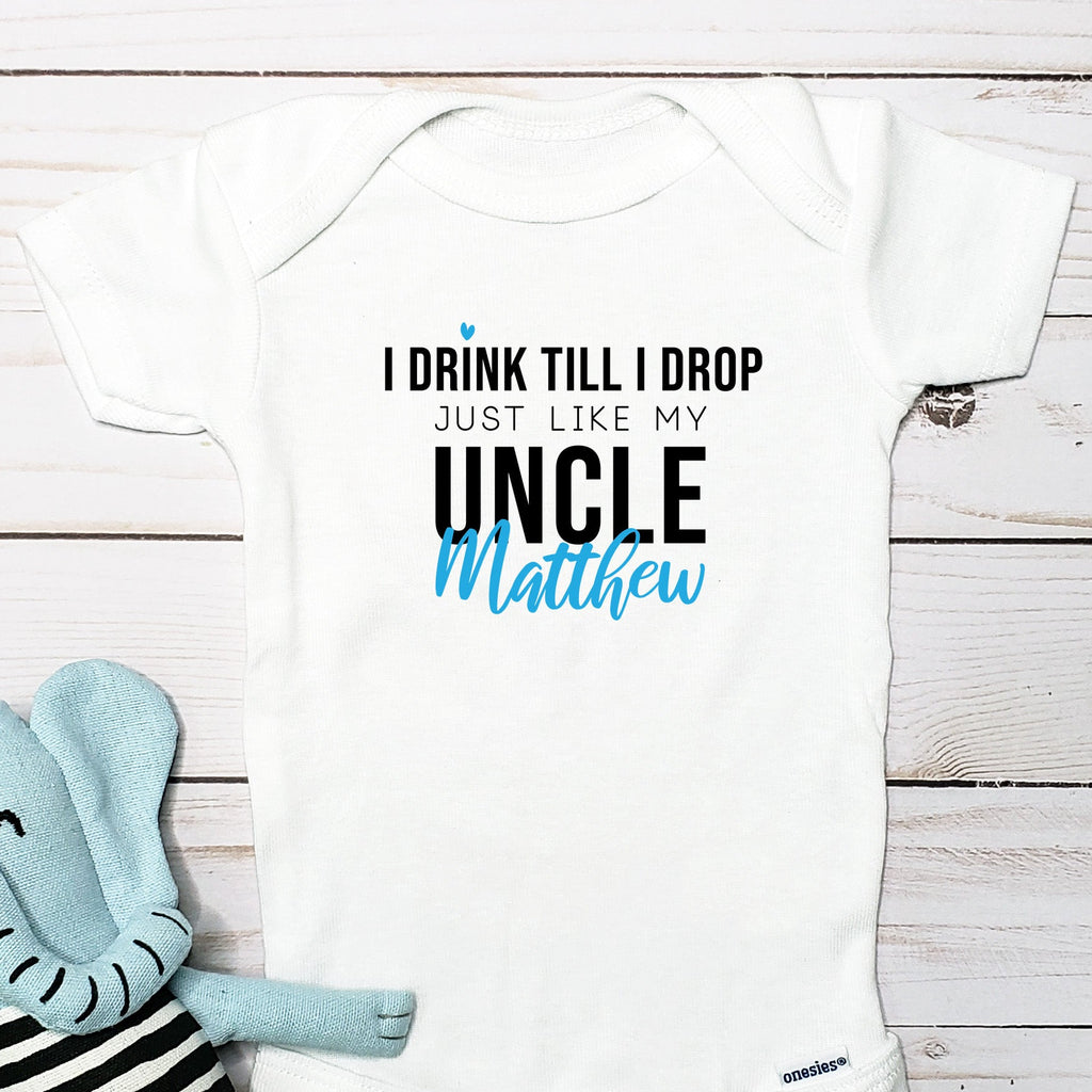 I Drink Till I Drop, Just Like My Uncle personalized baby bodysuit lifestyle photo - white bodysuit displayed near elephant nursery decor