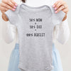 50% Mom, 50% Dad = 100% Perfect baby bodysuit lifestyle photo - gray bodysuit being held by an adult