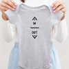 In and Out baby bodysuit lifestyle photo - gray bodysuit being held by an adult