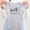 Birth: Nailed It baby bodysuit lifestyle photo - gray bodysuit being held by an adult