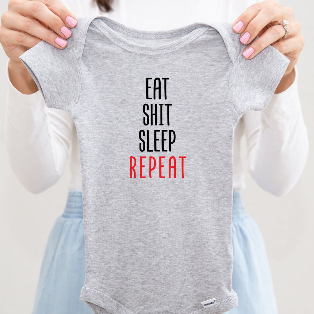 Eat Shit Sleep Repeat baby bodysuit lifestyle photo - gray bodysuit being held by an adult
