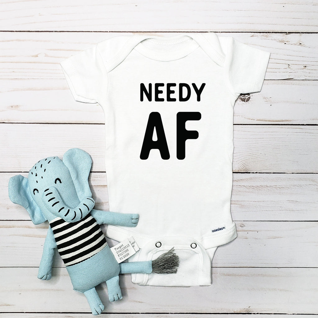 Needy AF baby bodysuit lifestyle photo - white bodysuit displayed near elephant nursery decor