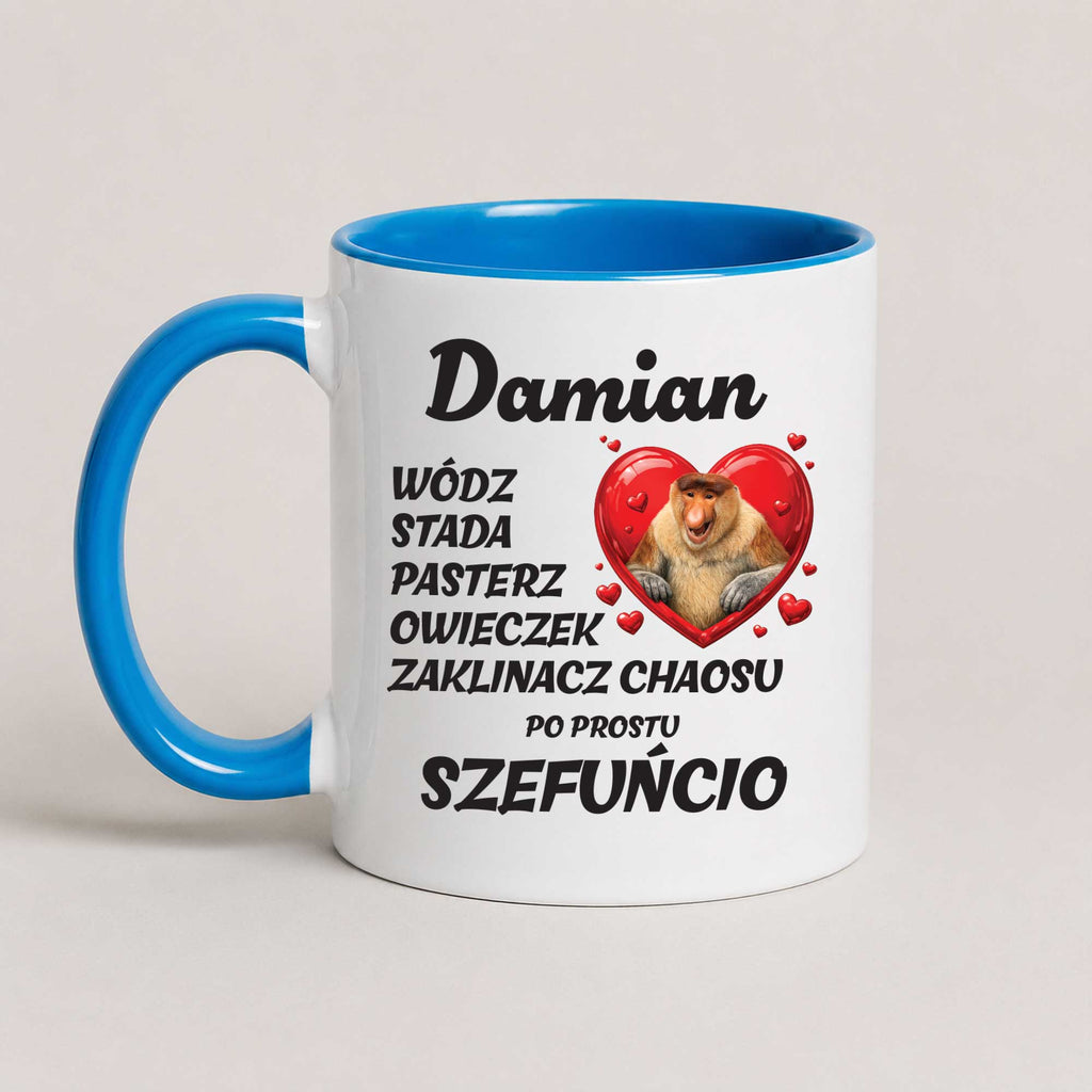 A white ceramic coffee mug with a bright blue handle and interior, featuring a printed Polish text design and a cartoon cat inside a red heart.