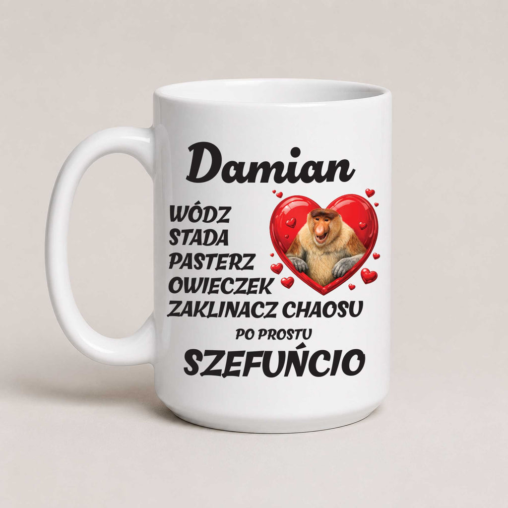 A white ceramic coffee mug with a humorous Polish inscription about Damian, a chameleon, alongside a graphic of a chameleon inside a red heart.