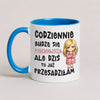 A white ceramic mug with a bright blue handle and interior, featuring Polish text and a cartoon illustration of a blonde girl in a pink robe.