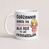 A white ceramic coffee mug with Polish text and a cartoon illustration of a blonde woman in a pink robe, shown on a light beige background.
