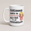 A white ceramic mug with a humorous Polish quote printed in black and pink text, featuring a cartoon illustration of a blonde woman in a pink coat. The mug is photographed against a neutral, light beige background.