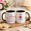 Two personalized white ceramic mugs with black rims and handles, displayed on a wooden tray. The left mug has a black handle and reads 'Pamiętaj Mariusz Będę Cię kochać i pamiętać do końca moich dni!!!' with red and black text and heart accents.