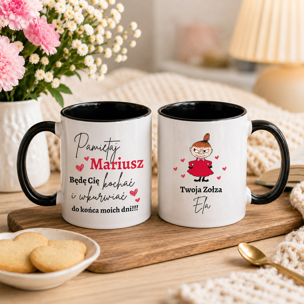 Two personalized white ceramic mugs with black rims and handles, displayed on a wooden tray. The left mug has a black handle and reads 'Pamiętaj Mariusz Będę Cię kochać i pamiętać do końca moich dni!!!' with red and black text and heart accents.