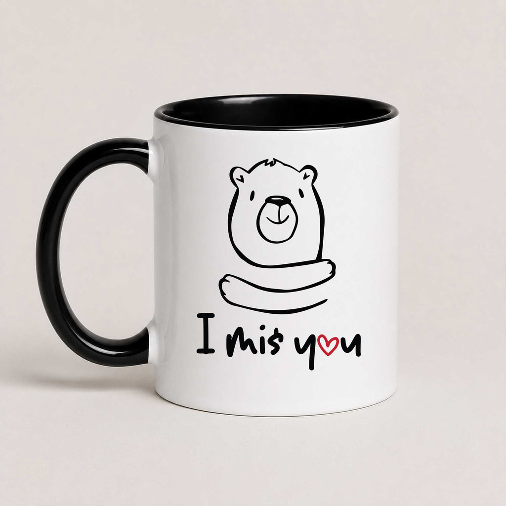 A Black 11oz ceramic mug with a hand-drawn bear illustration and the text 'I Miś You' with a small red heart