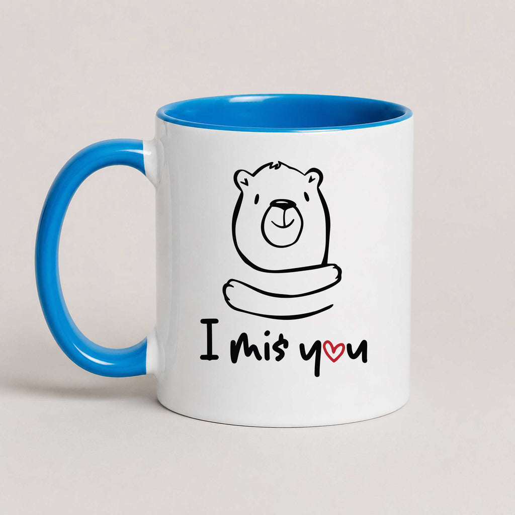 A Blue 11oz ceramic mug with a hand-drawn bear illustration and the text 'I Miś You' with a small red heart