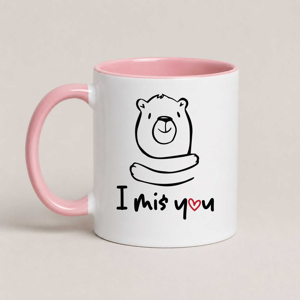 A Pink 11oz ceramic mug with a hand-drawn bear illustration and the text 'I Miś You' with a small red heart