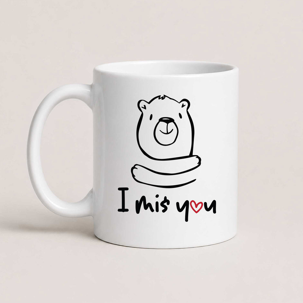 A White 11oz ceramic mug with a hand-drawn bear illustration and the text 'I Miś You' with a small red heart