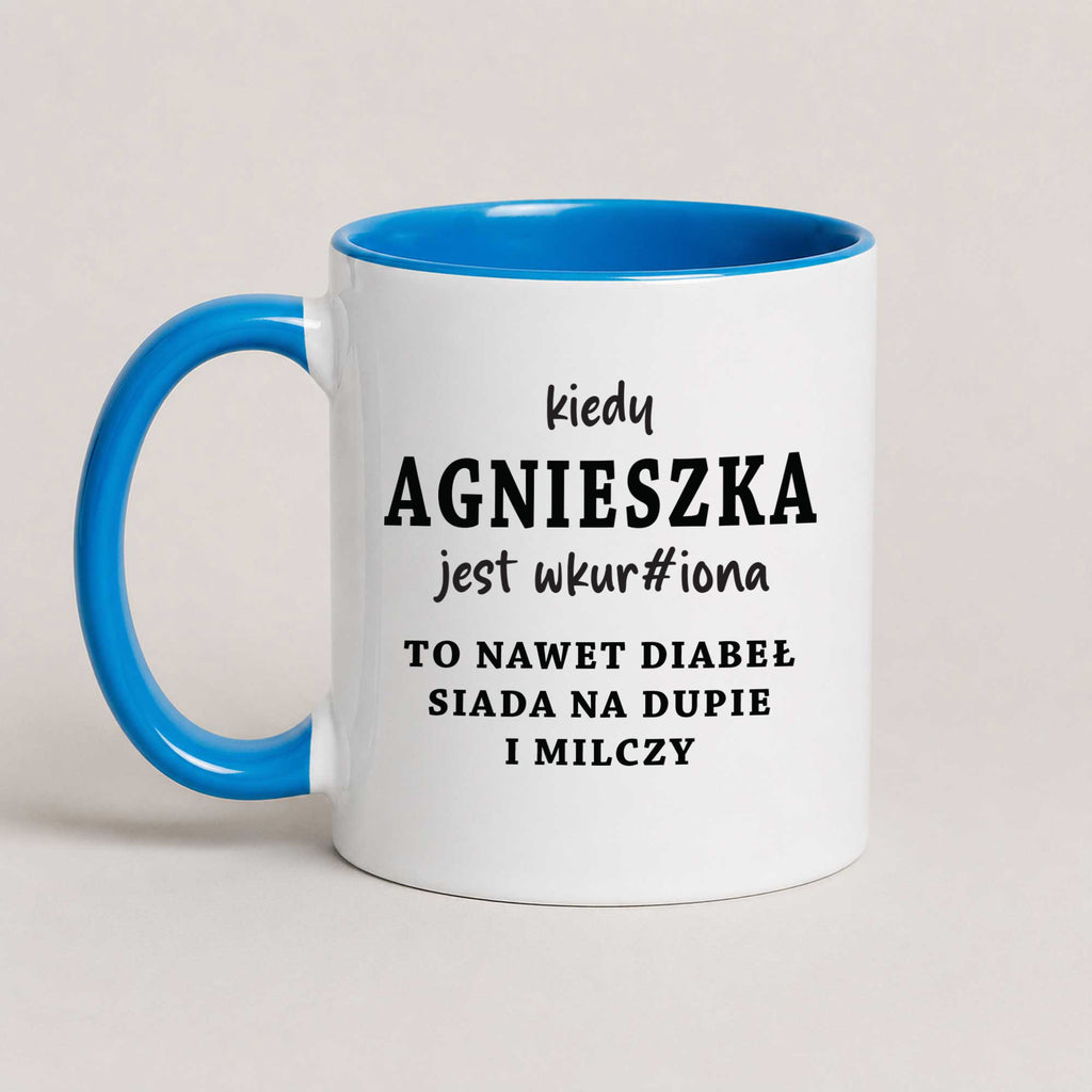 A Blue 11oz ceramic mug with the personalized Polish quote 'Kiedy Agnieszka jest wkur#iona, to nawet diabeł siada na dupie i milczy', customizable with any name