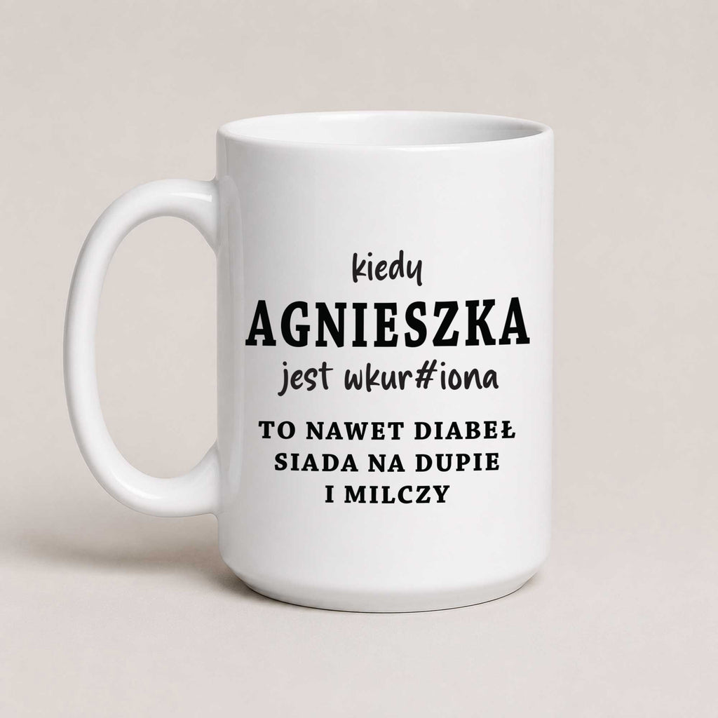 A White 15oz ceramic mug with the personalized Polish quote 'Kiedy Agnieszka jest wkur#iona, to nawet diabeł siada na dupie i milczy', customizable with any name