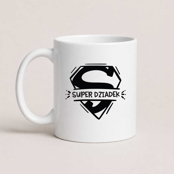 A White 11oz ceramic Polish coffee mug featuring a bold superhero-inspired 'Super Dziadek' design