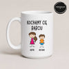 Close-up view of a White 15oz ceramic Polish coffee mug featuring custom grandchildren illustrations, names, and the message 'Kochamy Cię Babciu'
