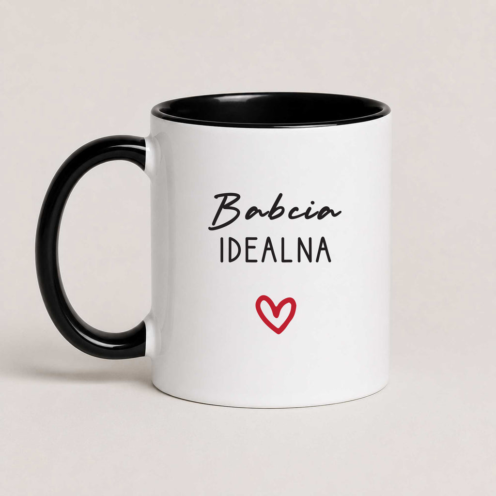 A Black 11oz ceramic Polish coffee mug featuring the 'Babcia Idealna' design with a delicate heart accent
