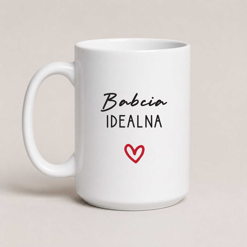 A White 15oz ceramic Polish coffee mug featuring the 'Babcia Idealna' design with a delicate heart accent