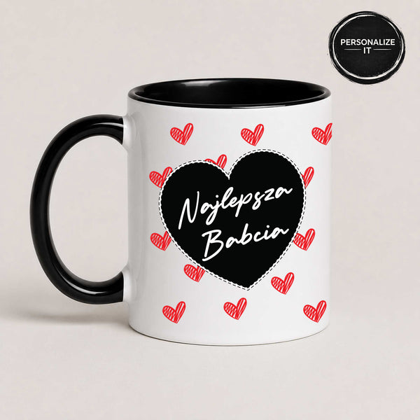 Close-up view of a Black 11oz ceramic Polish coffee mug featuring the 'Najlepsza Babcia' design with a bold black heart and red heart pattern