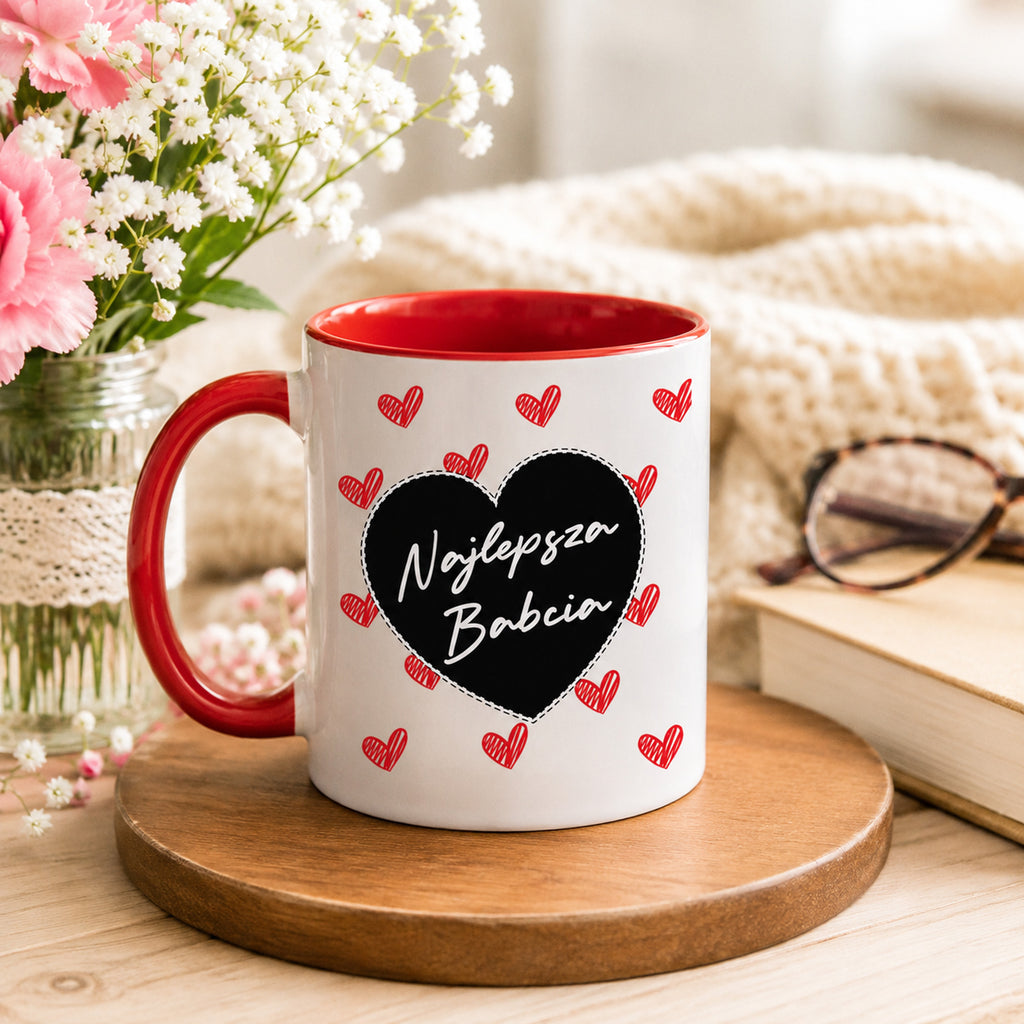 Lifestyle photo of the Polish mug featuring the 'Najlepsza Babcia' design with a bold black heart and red heart pattern