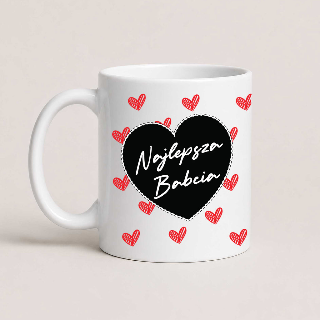 A White 11oz ceramic Polish coffee mug featuring the 'Najlepsza Babcia' design with a bold black heart and red heart pattern