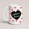A White 15oz ceramic Polish coffee mug featuring the 'Najlepsza Babcia' design with a bold black heart and red heart pattern