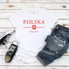 White Polska Poland T-shirt with red lettering and Polish eagle shield on flat lay with jeans and sneakers