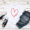 Woman wearing white T-shirt with white heart outline and Polska script